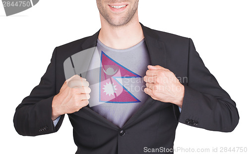 Image of Businessman opening suit to reveal shirt with flag