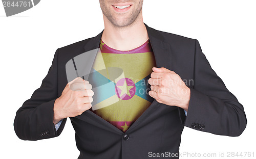 Image of Businessman opening suit to reveal shirt with flag