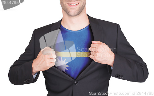 Image of Businessman opening suit to reveal shirt with flag