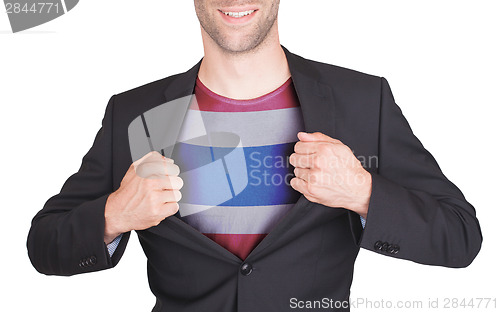 Image of Businessman opening suit to reveal shirt with flag