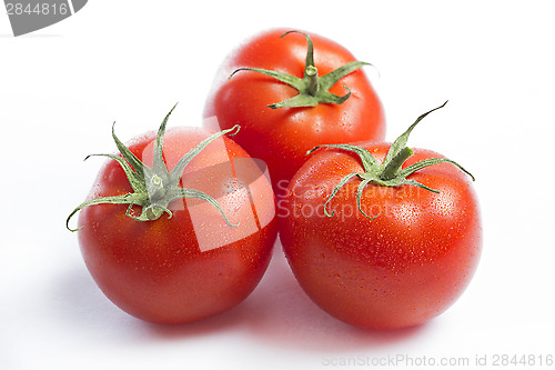 Image of Three red tomatoes on a white background