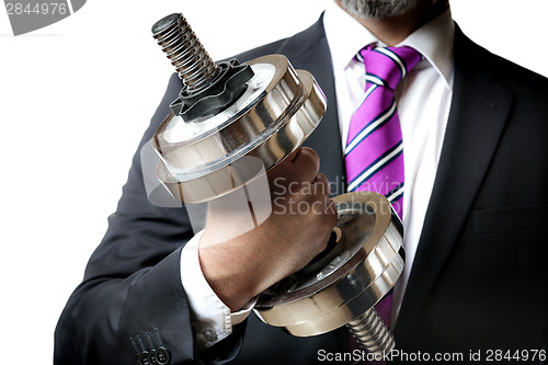 Image of Businessman holding silver dumbbell