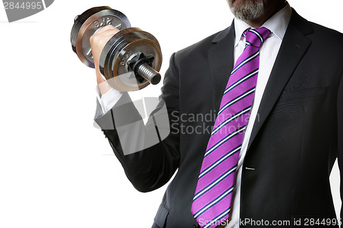 Image of Businessman holding silver dumbbell