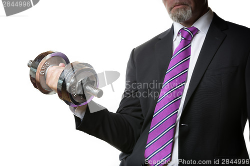 Image of Businessman holding silver dumbbell