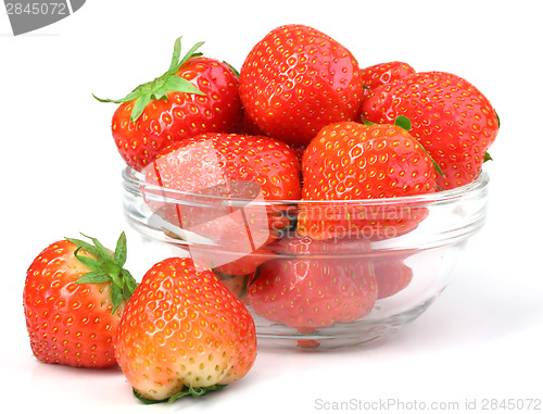 Image of Red strawberries in transparent plate on white