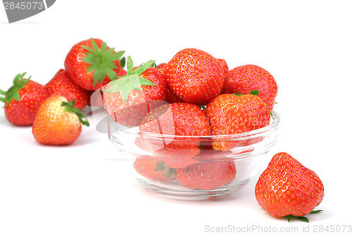 Image of Red strawberries in transparent plate on white