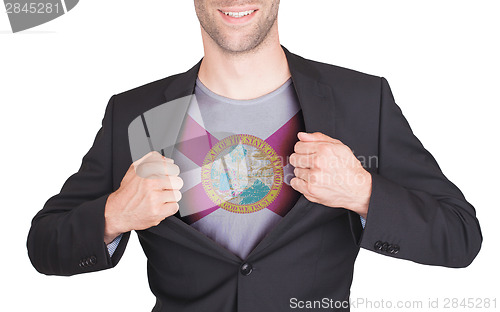 Image of Businessman opening suit to reveal shirt with state flag