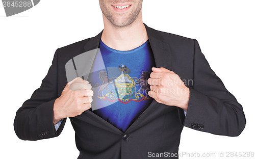 Image of Businessman opening suit to reveal shirt with state flag