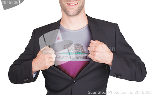 Image of Businessman opening suit to reveal shirt with state flag