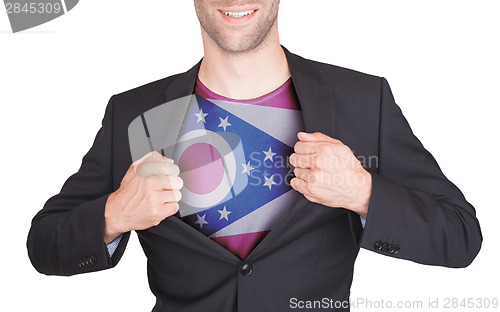 Image of Businessman opening suit to reveal shirt with state flag