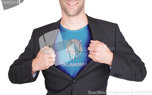 Image of Businessman opening suit to reveal shirt with state flag