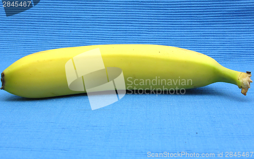 Image of Banana lying in front of a blue background