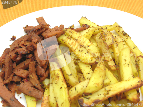 Image of Soy Geschnetzeltes and french fries on white plate