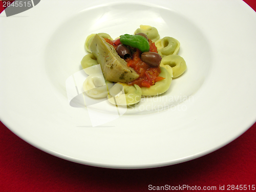 Image of Tortellini  with tomato sauce, olives, basil  and artichoke