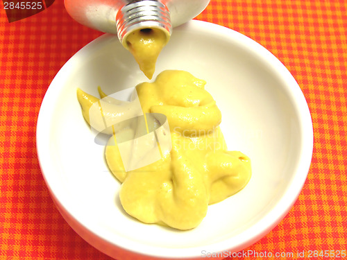 Image of Mustard  pressed out of a mustard tube in a little bowl