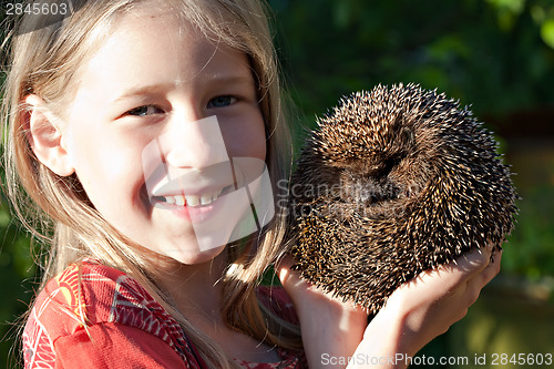 Image of little girl with cute hedgehog 