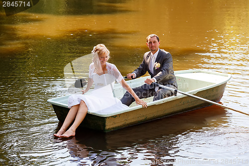 Image of Young just married bride and groom on boat