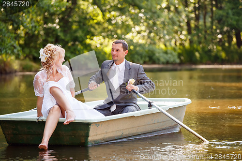 Image of Young just married bride and groom on boat