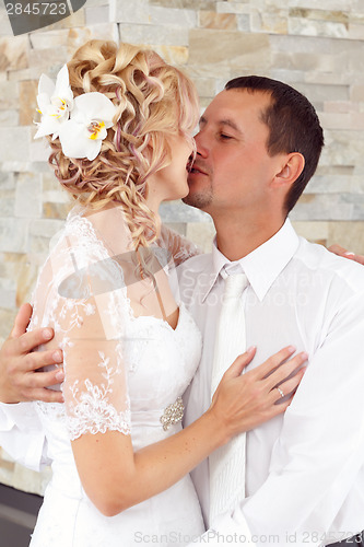 Image of beautiful young wedding couple kissing