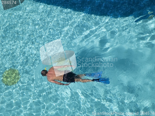 Image of Man snorkeling in swimming-pool.