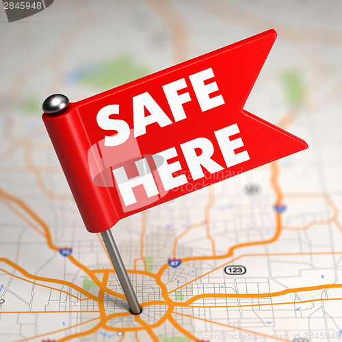 Image of Safe Here - Small Flag on a Map Background with.