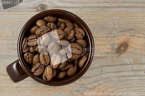 Image of brown cup with coffee beans