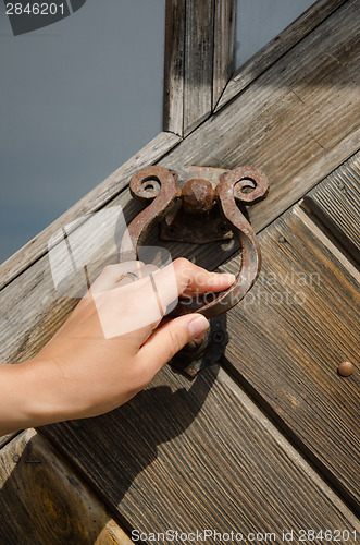 Image of guest hand knock retro door handle buzzer ringer 