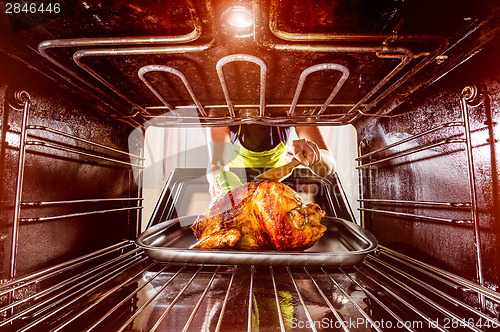 Image of Cooking chicken in the oven at home.