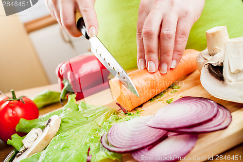 Image of Woman's hands cutting vegetables