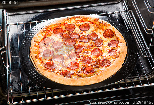 Image of Pepperoni pizza in the oven.