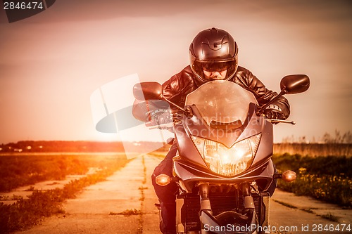 Image of Biker racing on the road