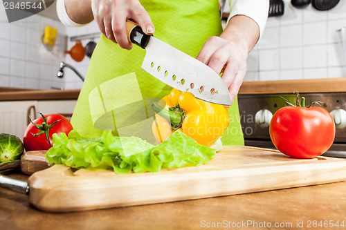 Image of Woman's hands cutting vegetables