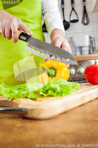 Image of Woman's hands cutting vegetables