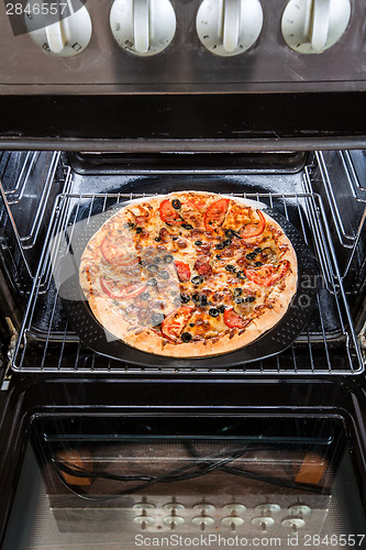 Image of Pepperoni pizza in the oven.