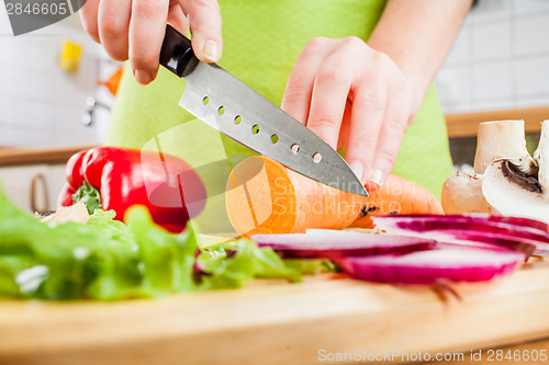 Image of Woman's hands cutting vegetables
