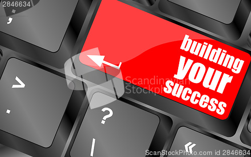 Image of building your success words on button or key showing motivation for job or business