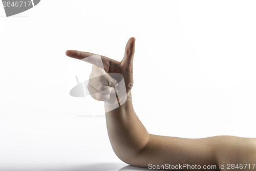 Image of Young hands makes gun sign