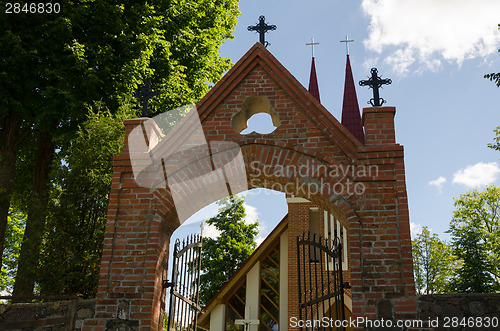 Image of gothic church door with crosses in summer time 