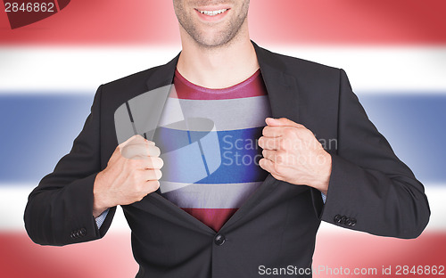 Image of Businessman opening suit to reveal shirt with flag