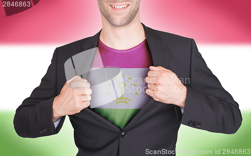 Image of Businessman opening suit to reveal shirt with flag