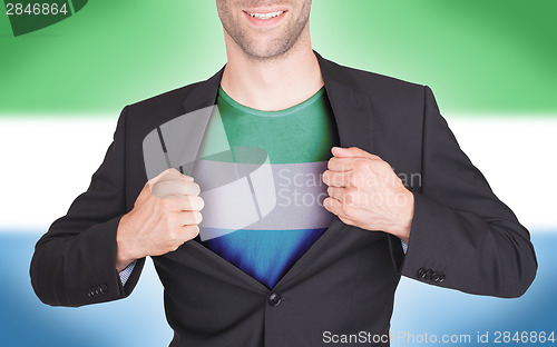 Image of Businessman opening suit to reveal shirt with flag