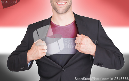 Image of Businessman opening suit to reveal shirt with flag