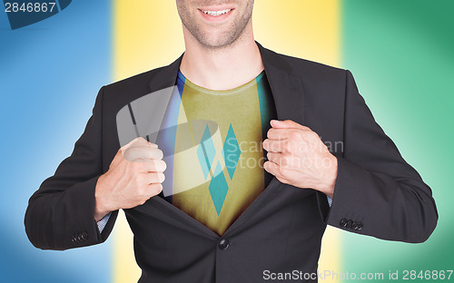 Image of Businessman opening suit to reveal shirt with flag