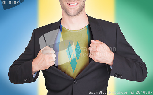 Image of Businessman opening suit to reveal shirt with flag