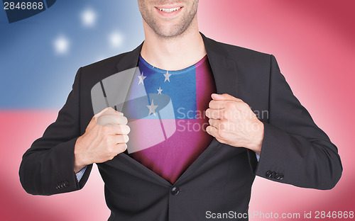 Image of Businessman opening suit to reveal shirt with flag