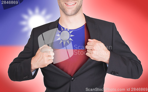 Image of Businessman opening suit to reveal shirt with flag