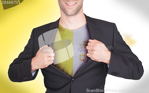 Image of Businessman opening suit to reveal shirt with flag