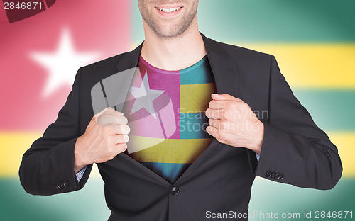 Image of Businessman opening suit to reveal shirt with flag