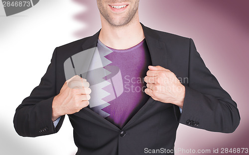 Image of Businessman opening suit to reveal shirt with flag