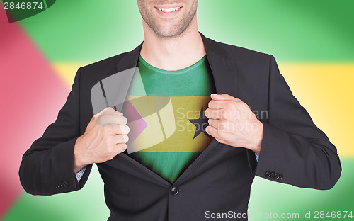 Image of Businessman opening suit to reveal shirt with flag